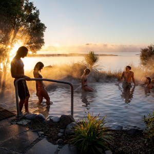 A group of friends enjoying the Deluxe Lake Spa Hot Pools on Lake Rotorua