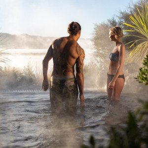 A couple enjoying the hot pools in the Deluxe Lake Spa area at Polynesian Spa